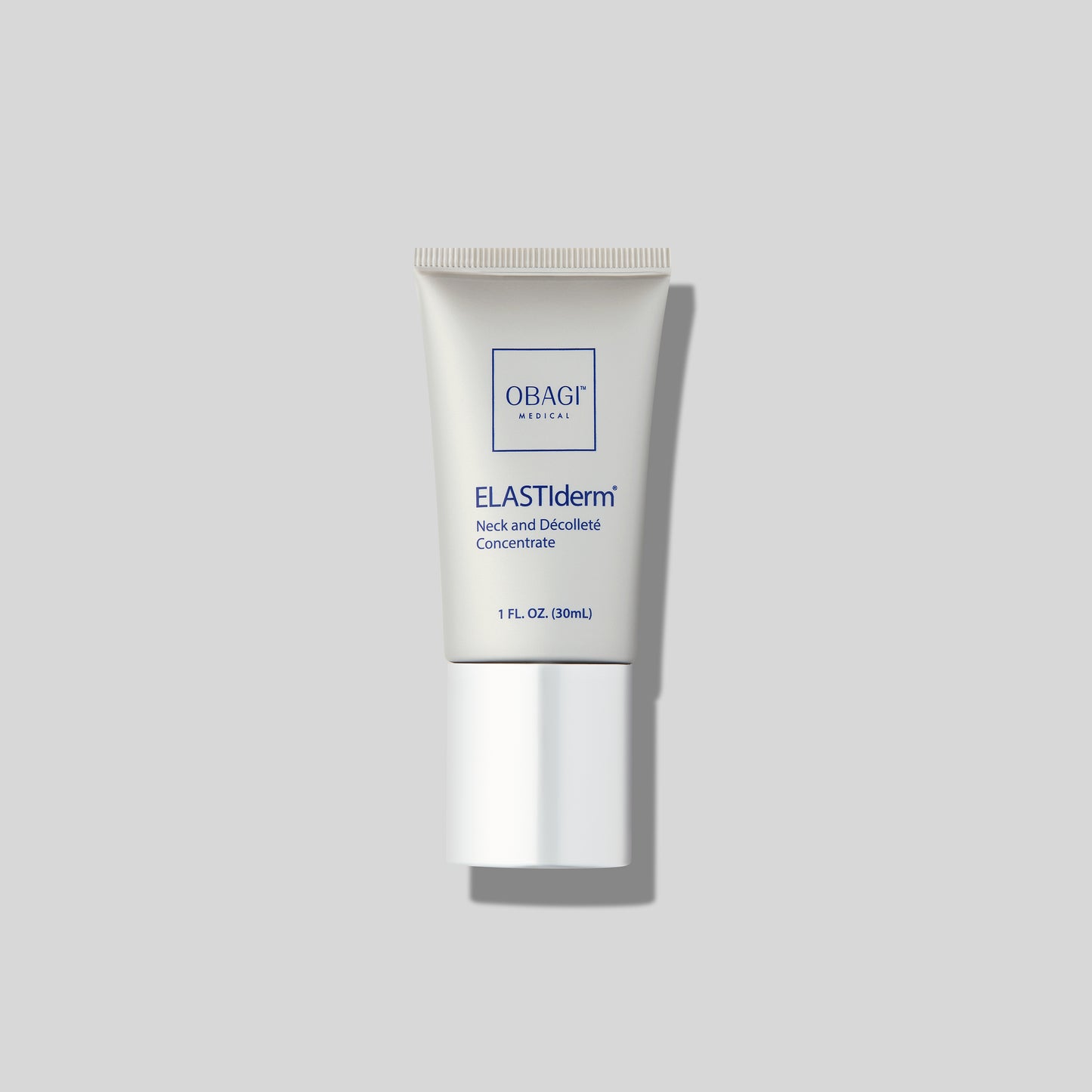 Obagi Medical ELASTIderm Neck and Décolleté Concentrate tube on a light gray background, featuring simple, clean packaging with blue text.