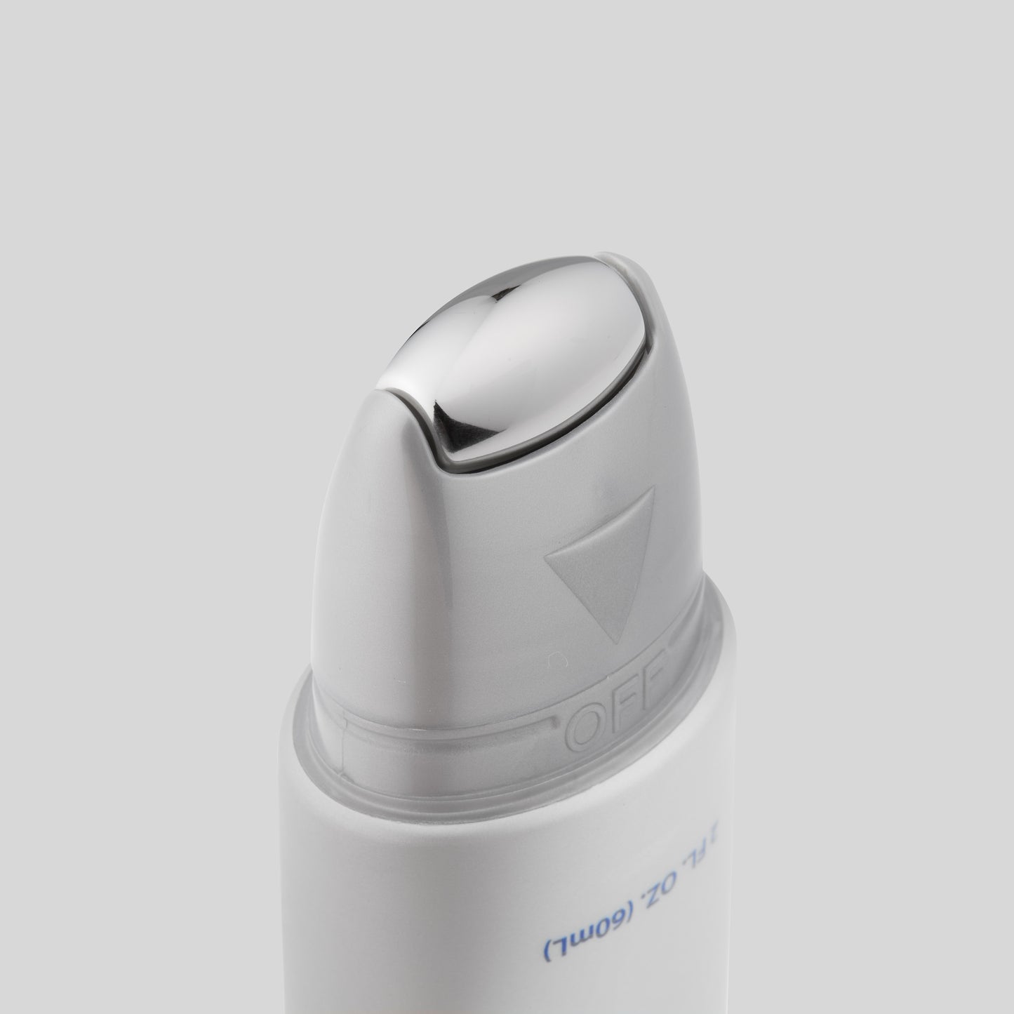 Close-up of the applicator tip of the Obagi Medical ELASTIderm Facial Serum, featuring a smooth, silver metallic design with an 'OFF' indicator on the nozzle.