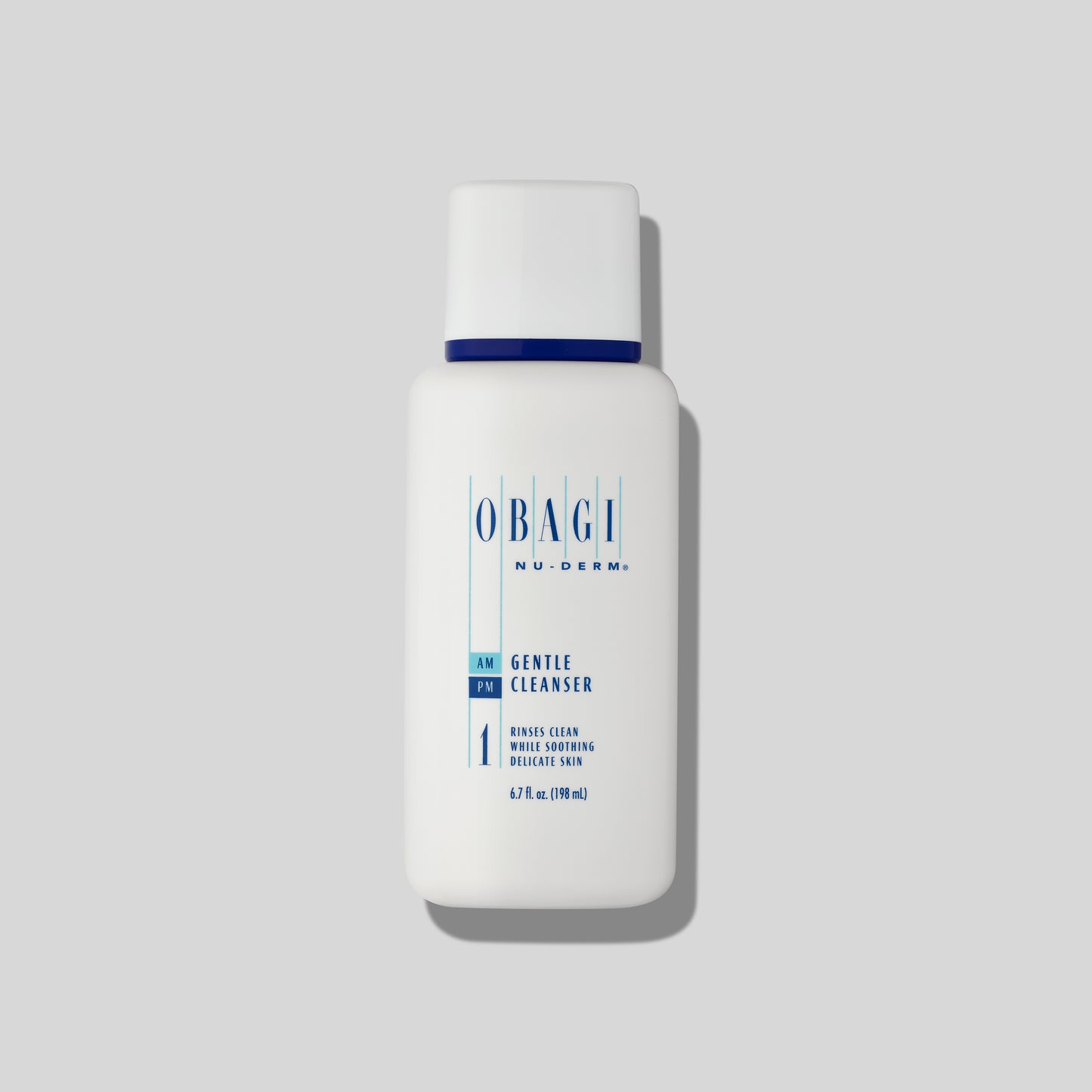 A full bottle of Obagi Nu-Derm® Gentle Cleanser standing on a white marble surface with soft lighting, featuring a clean, minimalist design. The cleanser is formulated to gently remove impurities and refresh the skin.
