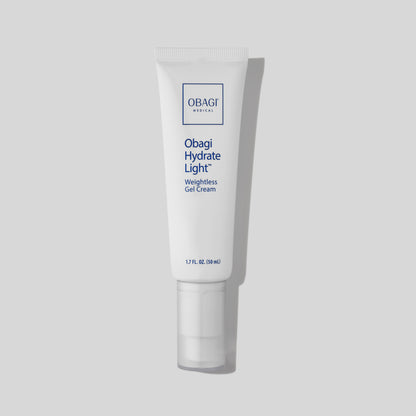 A clean white tube of Obagi Hydrate Light Moisturizer placed upright on a minimal beige background. It offers lightweight, long-lasting hydration for sensitive and oily skin types.